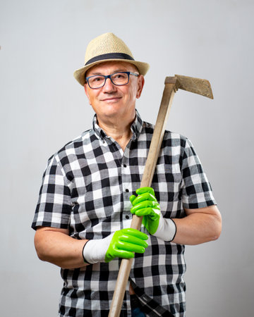 Farmer with squared shirt and agriculture toolの写真素材