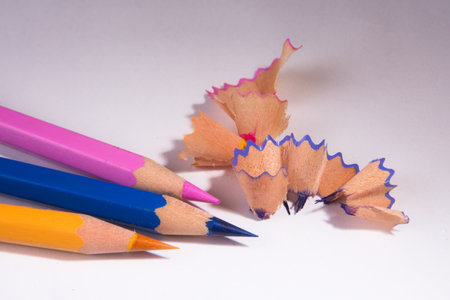 Pencils and sharpener shavings on a white background.