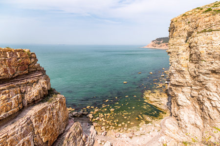 Rocky Cliffs and clear waters in Jiuzhangya Scenery Spot in Changdao Island, located near Yantai, Shandong, Chinaの写真素材
