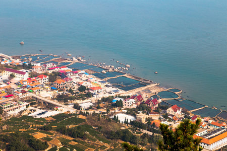 Fishing villages on the coast of Laoshan Mountain seen from Na Luo Yan Ku Trail, Qingdao, Chinaの写真素材