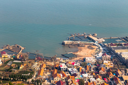 Fishing villages on the coast of Laoshan Mountain seen from Na Luo Yan Ku Trail, Qingdao, Chinaの写真素材