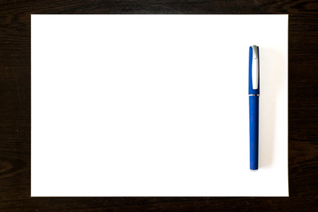 Isolated blue pen on a white paper sheet, template ready for your designの写真素材