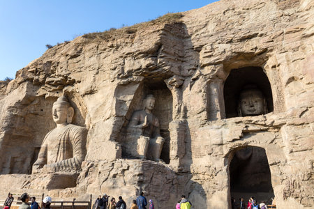 November 2014 - Datong, China - Tourists exploring the Yungang Grottoes in Datong, displaying some of the most beautifully crafted buddhist statues of Chinaのeditorial素材
