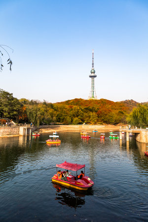 Small pond with boats in Zhongshan Park in Autumn, Qingdao, Chinaのeditorial素材