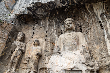 Main Buddha statue in Fengxiangsi Cave, the main one in the Longmen Grottoes in Luoyang, Henan, China. Longmen is one of the 3 major Buddhist caves of Chinaの写真素材