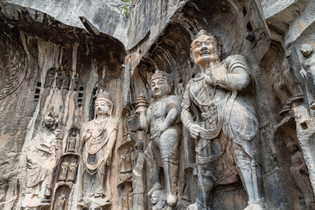 Buddhist sculptures in Fengxiangsi Cave, the main one in the Longmen Grottoes in Luoyang, Henan, China. Longmen is one of the 3 major Buddhist caves of Chinaの写真素材