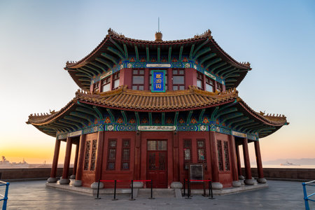 Zhanqiao pier at sunrise, Qingdao, Shandong, China. The name "Huilan Pavilion" is engraved above the entrance door.のeditorial素材