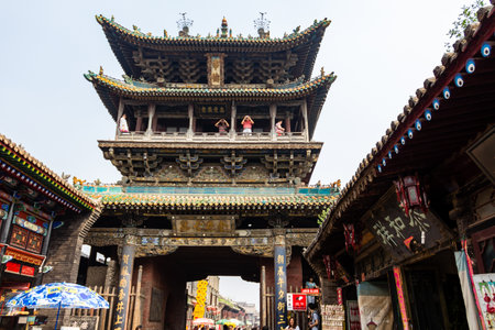 Aug 2013 - Pingyao, Shanxi, China - Tourists on the Tower in South Street of Pingyao, one of the main roads of the old city. Pingyao is a UNESCO world Heritage siteのeditorial素材