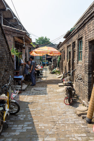 Aug 2013 - Pingyao, Shanxi, China - Daily life scenes in one of the small streets of Pingyao ancient city. Pingyao is a UNESCO world Heritage siteのeditorial素材