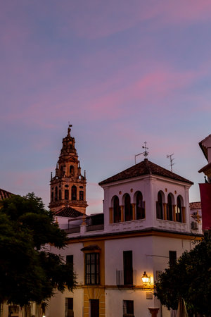 View of the bell tower and former minaret of Mezquita from the streets of Cordoba at sunset, Andalucia, Spainの写真素材