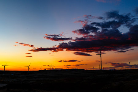 Aug 2017 â€“ Xinjiang, China â€“ Wind Turbines at sunset in Burqin County, North of...