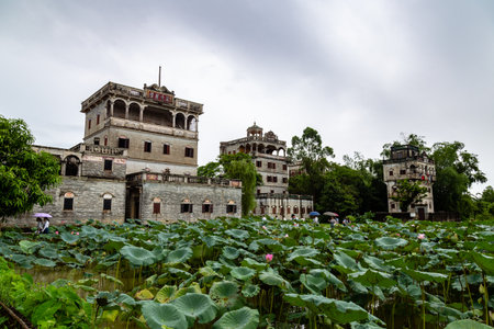 July 2017 â Kaiping, China - Kaiping Diaolou and lotus pond in Zili Village, near Guangzhou. Built by rich overseas Chinese, these family houses are a unique mix of Chinese and western architectureのeditorial素材