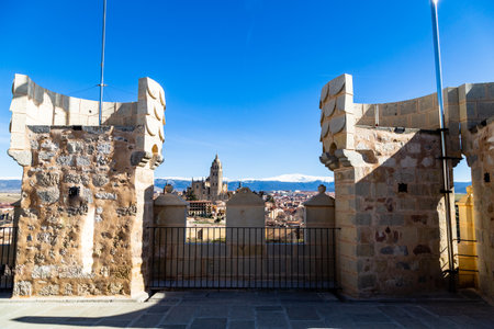 Segovia, Spain? View from Juan II tower in Winter time of the Alcazar of the old town of Segovia and the Cathedral with the snow capped Sierra de Guadarrama behindの写真素材