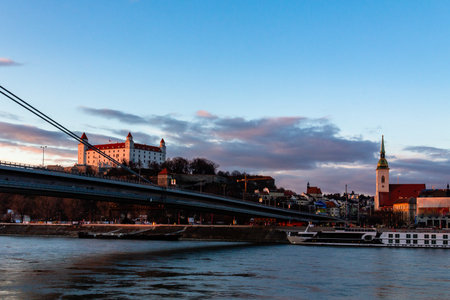 Bratislava, Slovakia: St. Martin Cathedral and the Castle at sunset seen from across the Danube riverのeditorial素材