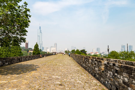 May 2017 - Nanjing, Jiangsu, China - Ming Dynasty city walls near Jiming temple. Nanjing skyline is visible in the backgroundのeditorial素材