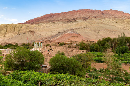 Tuyoq village (Tuyuk): panoramic view of this traditional uighur village set in lush valley cutting through the flaming mountains near Turpan, Xinjiang, Chinaの写真素材