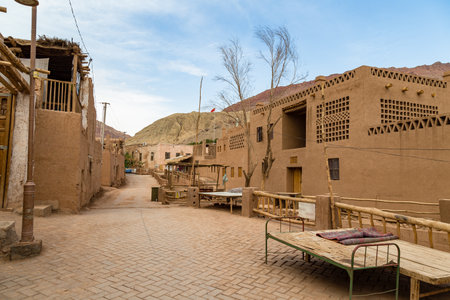 Tuyoq village (Tuyuk): one of the streets of this traditional uighur village set in a lush valley cutting through the flaming mountains near Turpan, Xinjiang, Chinaの写真素材