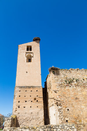 Pedraza, Castilla Y Leon, Spain: ruins of Iglesia de Santa Maria with giant bird's nests on top. Pedraza is one of the best preserved medieval villages of Spain, not far from Segoviaの写真素材