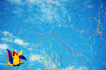 Joker hats on sky background with confetti and streamersの写真素材