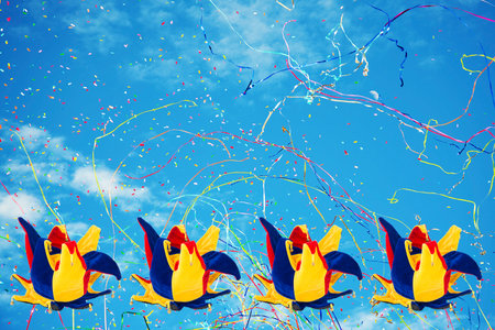 Joker hats on sky background with confetti and streamersの写真素材