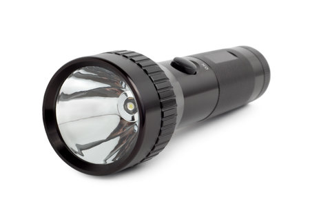 Black metallic flashlight isolated on a white background