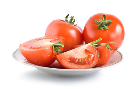 Tomatoes on a plate isolated on white backgroundの写真素材