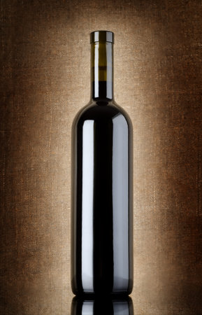 Wine bottle on a old canvasの写真素材
