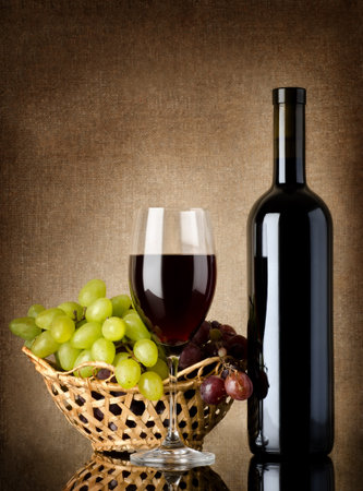 Wine and grapes on a old backgroundの写真素材