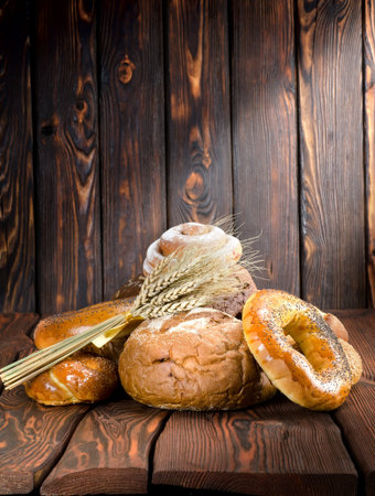 Bread on a old wooden boardsの写真素材