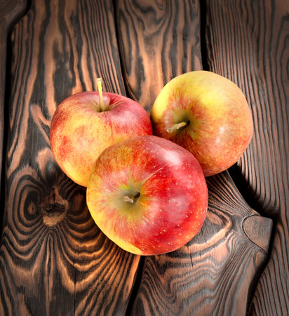 Red apples on the wooden tableの写真素材