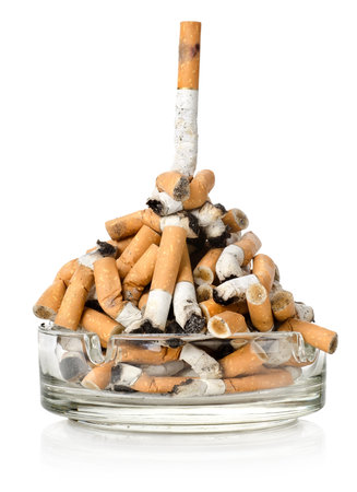Cigarettes in a glass ashtrayの写真素材