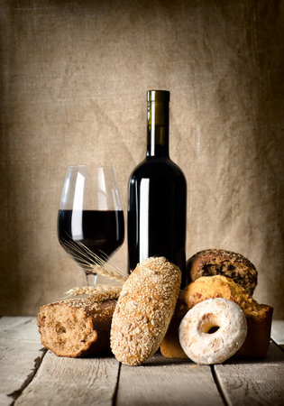 Wine and assortment of breadの写真素材