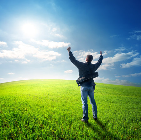 Happy young man looking at the sunの写真素材