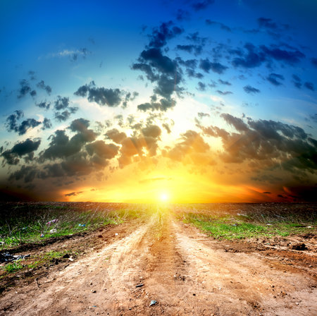 Country road and cumulus cloudsの写真素材