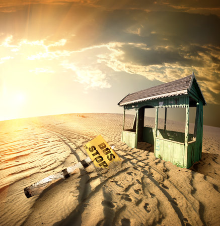 Bus stop in the desert at sunsetの写真素材