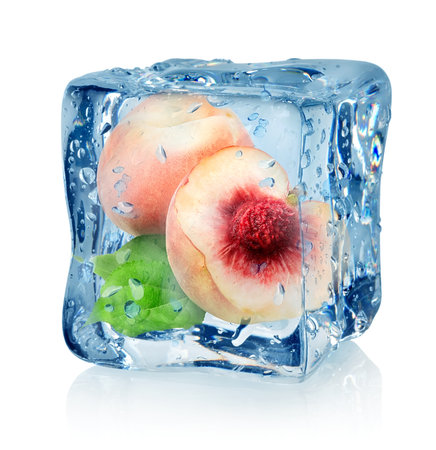 Ice cube and peach isolated on a white backgroundの写真素材