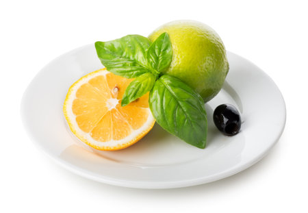 Citrus fruits with mint and olive in plate isolated on whiteの写真素材