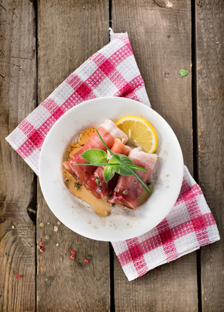 Bacon in plate on a wooden backgroundの写真素材