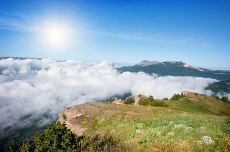 Meadow in the mountains over the cloudsの写真素材