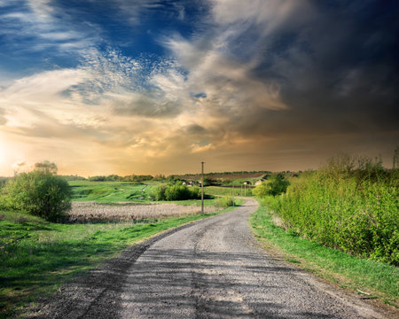 Country road in the countryside at sunsetの写真素材