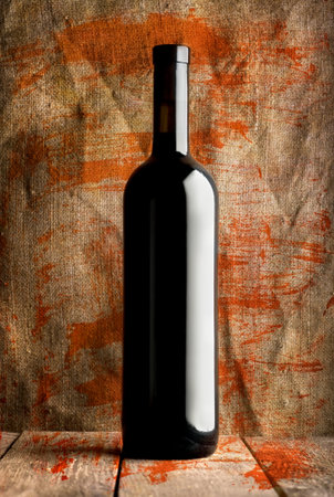 Bottle of red wine on a background of the canvasの写真素材