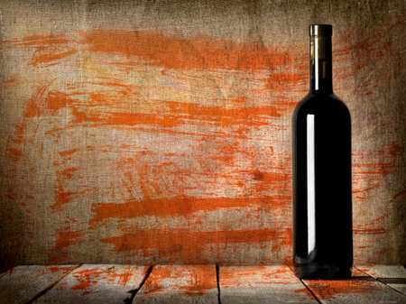 Black bottle of wine on the background of the canvasの写真素材