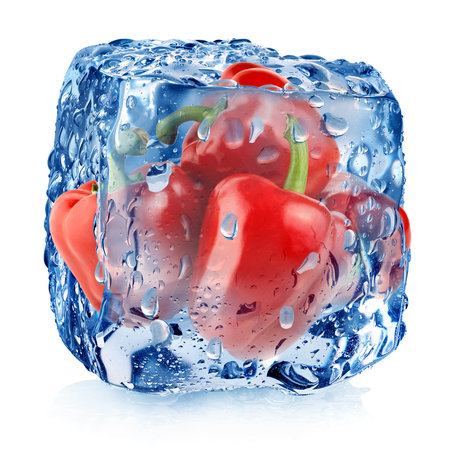 Red pepper in ice cube with drops isolated on whiteの写真素材