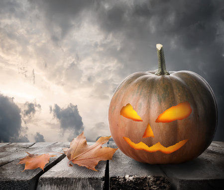 Fierce pumpkin on the table and dramatic skyの写真素材
