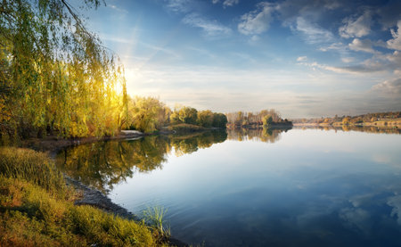 Morning sun over river in the autumnの写真素材