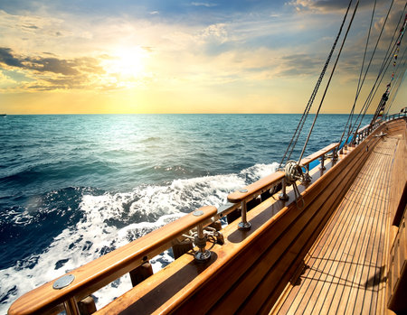 Sailboat in red sea at the sunsetの写真素材