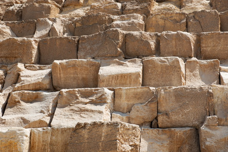 Brown stony wall of egyptian pyramid closeup