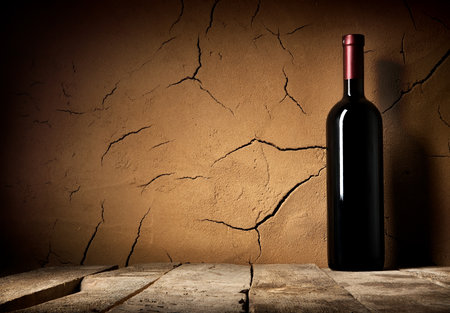 Bottle of cabernet in cellar near clay wallの写真素材