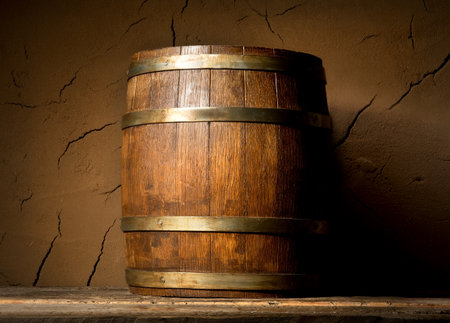 Wooden cask near clay wall in cellarの写真素材