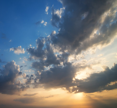 Background of cloudy sky and sun at sunsetの写真素材